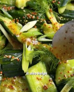 cucumbers and spices being mixed together in a bowl