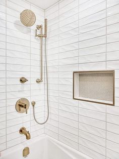 the shower head is mounted to the wall above the bathtub