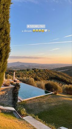 an outdoor swimming pool surrounded by greenery and hills in the background with text overlay that reads, a dream italy