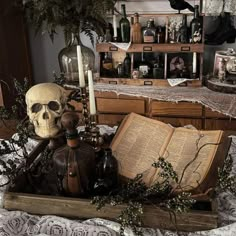 there is a skull sitting on top of an open book in the middle of a table