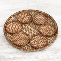 six cookies in a woven basket on a white wooden table top, ready to be eaten