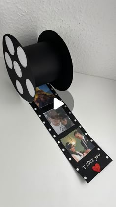 a black and white film reel with pictures on it's side that says i love you