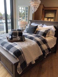 a large bed sitting inside of a bedroom next to a window