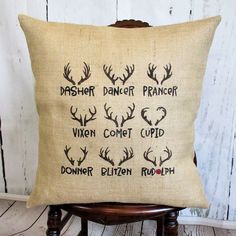 a pillow with the words dasher dancer, vign comet cupid and deer antlers on it