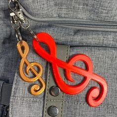 an orange treble keychain hanging from the pocket of someone's jeans