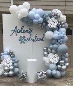 the balloon arch is decorated with snowflakes and balloons