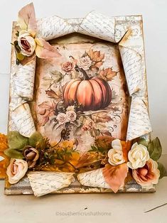 an old photo frame decorated with flowers and pumpkins