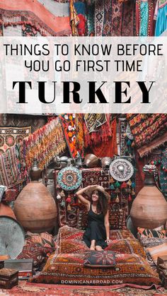 a woman sitting on top of a bed surrounded by rugs and vases with the words, things to know before you go first time turkey