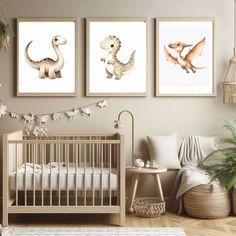 three dinosaur prints hanging on the wall in a baby's room