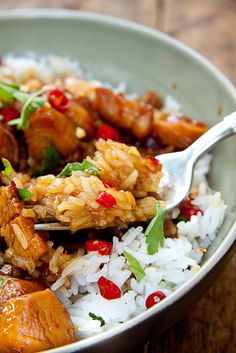 a white bowl filled with rice and meat