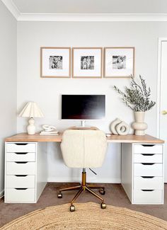 a home office with white furniture and pictures on the wall above it, along with a jute rug