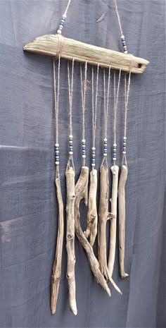 driftwood hanging on the wall with blue beads