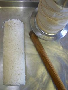 a roll of rice sitting on top of a metal pan