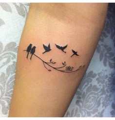 birds on a branch with flowers tattoo design on the left inner arm and lower arm