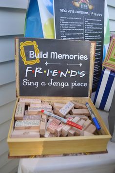 a wooden box filled with lots of different types of stamps and writing on top of a table