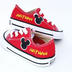 pair of red shoes with mickey mouse painted on the soles for children to wear