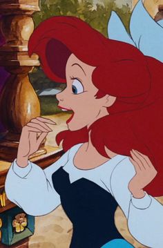 ariel from the little mermaid with her hands on her chest and looking at something in front of