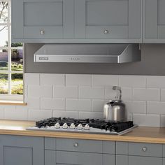 a stove top oven sitting inside of a kitchen