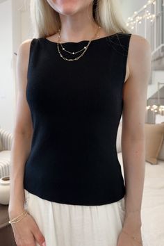 The Penelope Boat Neck Top in Black has a classic silhouette that can easily be dressed up or down! The timeless boat neckline on this blouse truly sets it apart. Featuring a knit fabric, black color, boat neckline and a true to size fit. Style this sleeveless top with a nice pair of trousers or jean shorts! Details & Sizing Knit fabric Black color Boat neckline True to size fit Gabriella is wearing a size S Fabric 40% Acrylic 32% Rayon 28% Polyester Shipping & Returns We offer $5 flat rate stan Boatneck Sleeveless Blouse, Boat Neckline Blouse, Boat Neckline Top, Bateau Neckline Top, Boatneck Top Outfit, Boat Neck Shirt Pattern, Black Sleeveless Top Outfit, Sleeveless Top Outfit Casual, Tailored Tops