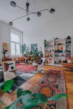 a living room filled with lots of furniture and plants on top of it's shelves