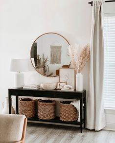 a table with baskets and a mirror on it