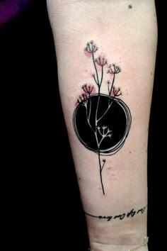 a black and white tattoo with flowers on the side of a woman's leg