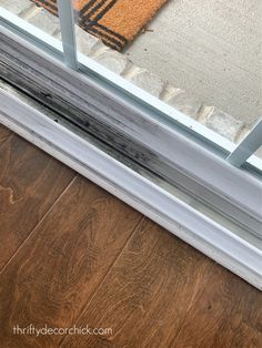 a close up of a window seal on the outside of a house with wood flooring