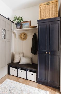 an entryway with storage cabinets and baskets on the floor, along with a rug