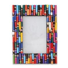 a multicolored photo frame made out of crayons and pencils on a white background