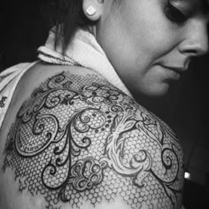 a woman with tattoos on her arm and shoulder