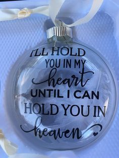 a glass ornament that says, i hold you in my heart until i can hold you in heaven