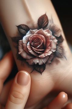 a woman's hand with a rose tattoo on it