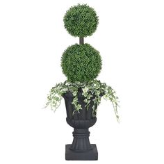 a potted plant on top of a black stand with two balls in it's center