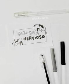 some pens are sitting on top of a white surface next to a sticker with the words sistema nervoso