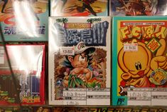 several video games are on display for sale in a store, including one with an image of gohan