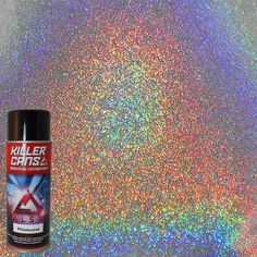 a can of paint sitting on top of a glitter covered floor next to a spray bottle