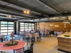 a large room with tables and chairs set up for an event or function in the center