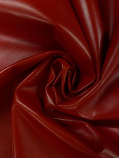 a close up view of a red leather fabric