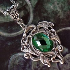 FREE Worldwide SHIPPING on all Orders over 130 € with Coupon Code : ONLYFORYOU ❦  GREEN "ELVE'S HEART" NECKLACE ❦  : Reveal your druidess soul with this elven necklace inspired by the magic of nature. Composed of a silver brass floral frame, it secretly protects a faceted green stone, the famous Elve's Heart ! The pendant measures 35mm or 1,4 inch height. Minimum neck size : 45 cm or 17,7 inches Maximum neck size : 56 cm or 22 inches This necklace closes with lobster clasp and extension chain. W Green Amulet Necklace, Fantasy Jewelry Magic, Elven Necklace, Fantasy Queen, Fantasy Necklace, Nature Light, Fairy Jewelry, Amulet Necklace, Green Forest