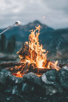 an image of a fire in the middle of some rocks with words written on it