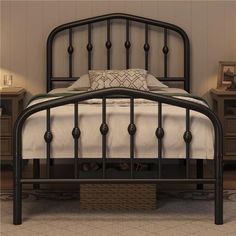 a black metal bed frame in a bedroom