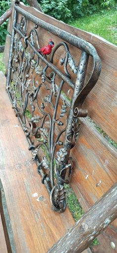 an old bench with a bird on it's back and some grass in the background