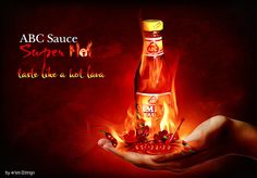 a bottle of hot sauce on fire in the palm of someone's hand