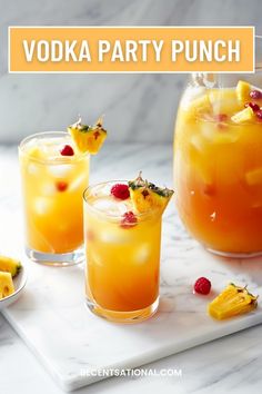 the vodka party punch is ready to be served with raspberries and pineapples