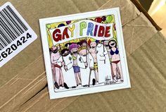 a sticker that says gay pride on it next to a box with an image of people in bathing suits