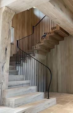 a wooden staircase with wrought iron handrails