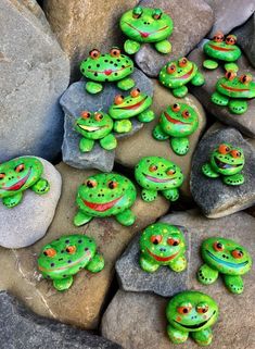 green frog figurines sitting on top of rocks