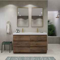 a bathroom with two mirrors above the sink and a rug on the floor next to it