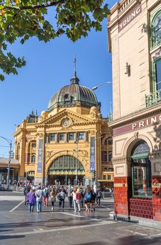 people walking in front of an old building