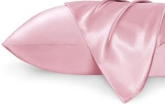 a pink satin pillow with a knot on it's side and a white background